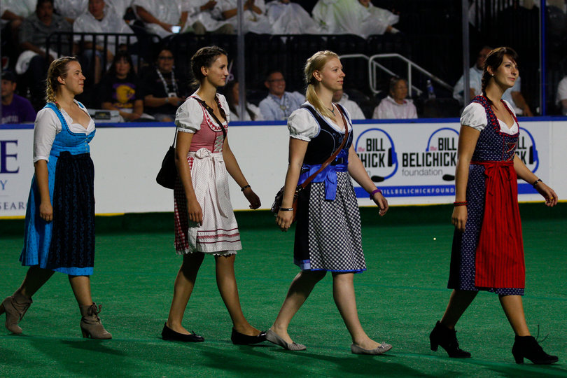 Four people in traditional dresses walked out with the German team during the festivities.