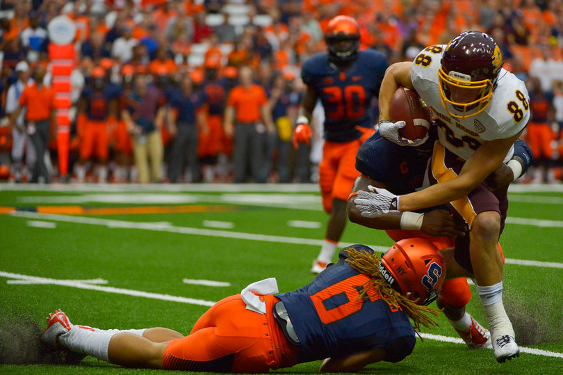 Williams (6) helps put a tackle on a CMU's Jesse Kroll.