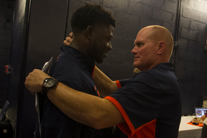 Shafer embraces linebacker Parris Bennett after the game. Bennett had a fourth-quarter fumble recovery.