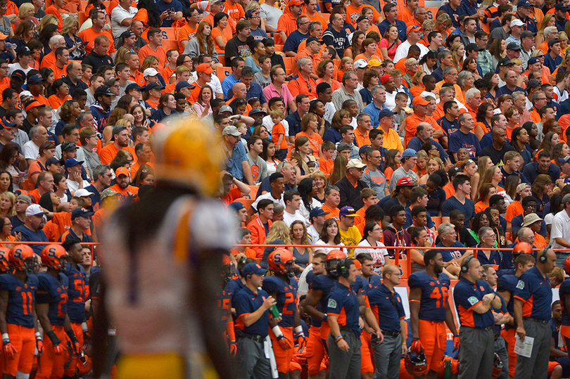 LSU defensive back Donte Jackson, the SU bench and fans look downfield.