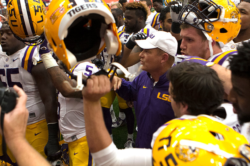 LSU head coach Les Miles and his players walk off the field after their 34-24 win against SU. 
