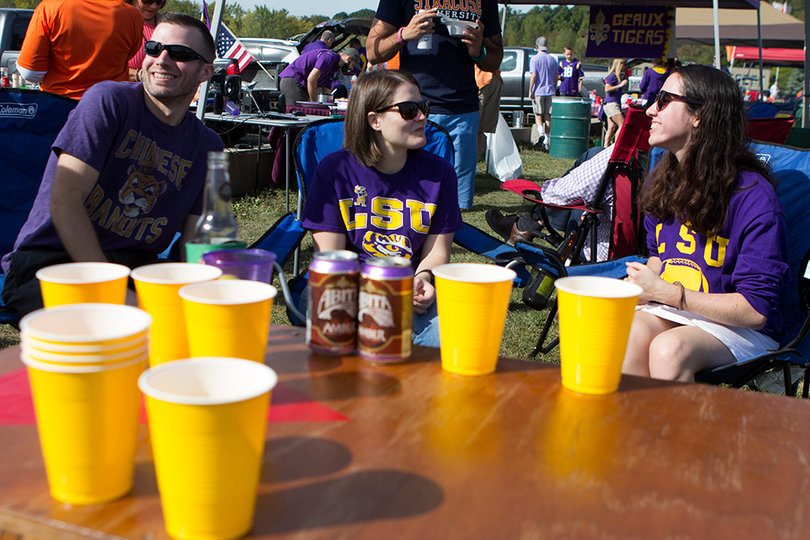 Chris House, Julie Wiacek and Sarah deVeer talk during their tailgate before the Tigers beat the Orange, 34-24. 