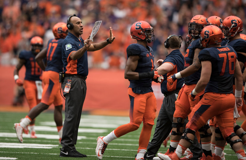 Tight ends and tackles coach Jake Moreland speaks to Syracuse players on the sideline.