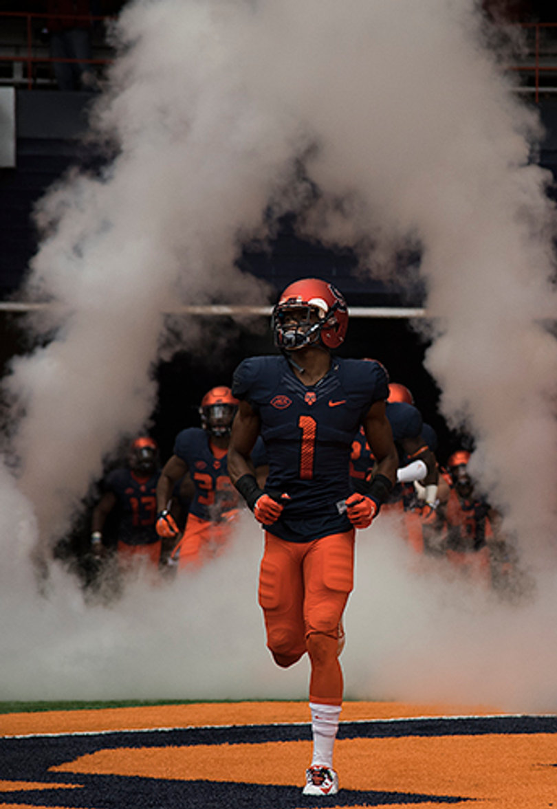 Senior cornerback Julian Whigham leads Syracuse out of the tunnel before taking on No. 8 LSU.