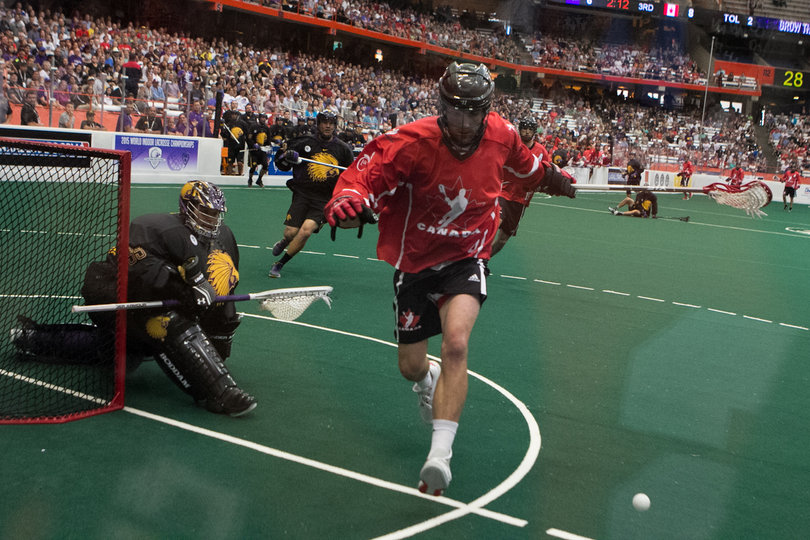 Canadian defender Kyle Rubisch chases a ball into the corner of the field. 