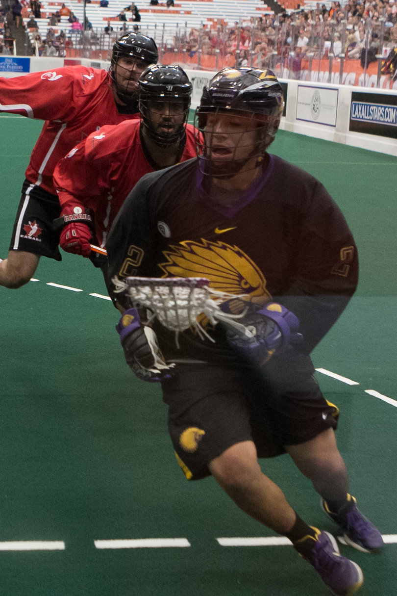 Iroquois forward Miles Thompson is chased down by two Canadian players. Thompson scored one goal and assisted on two others. 