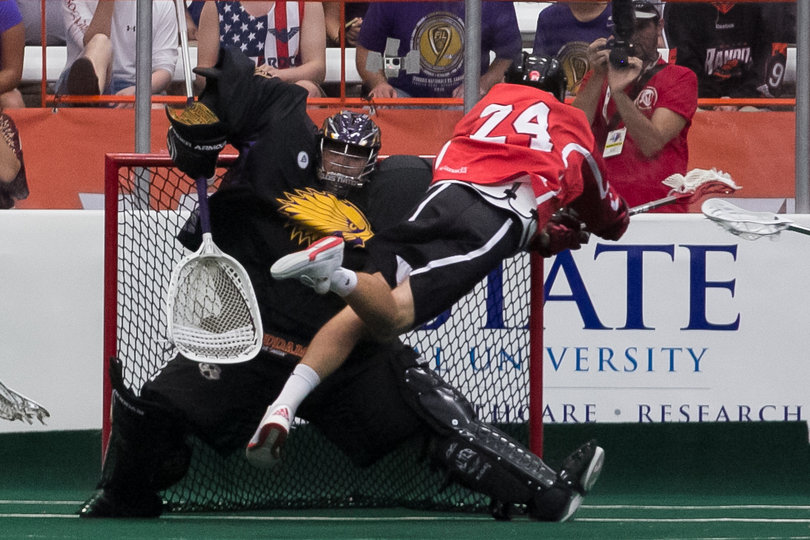 Canadian transition player Jordan MacIntosh dives over the crease and toward  the net. 