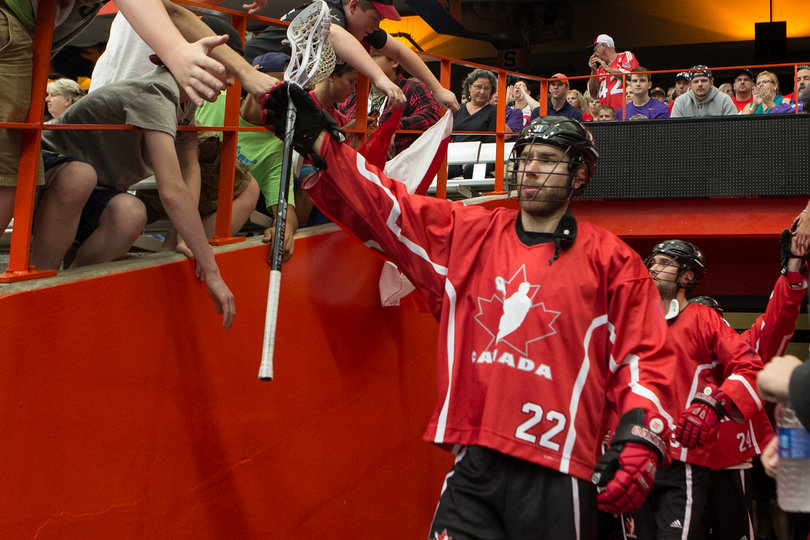 Canadian defender Ryan Dilks (22) leads a small pack of players out of the Carrier Dome tunnel. 