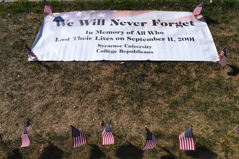 A banner commemorating those who lost their lives during the tragic events on Sept. 11, 2001 is placed on one of the main infields at SU. Five students who attend the university took several hours to place the flags in honor of those who died.