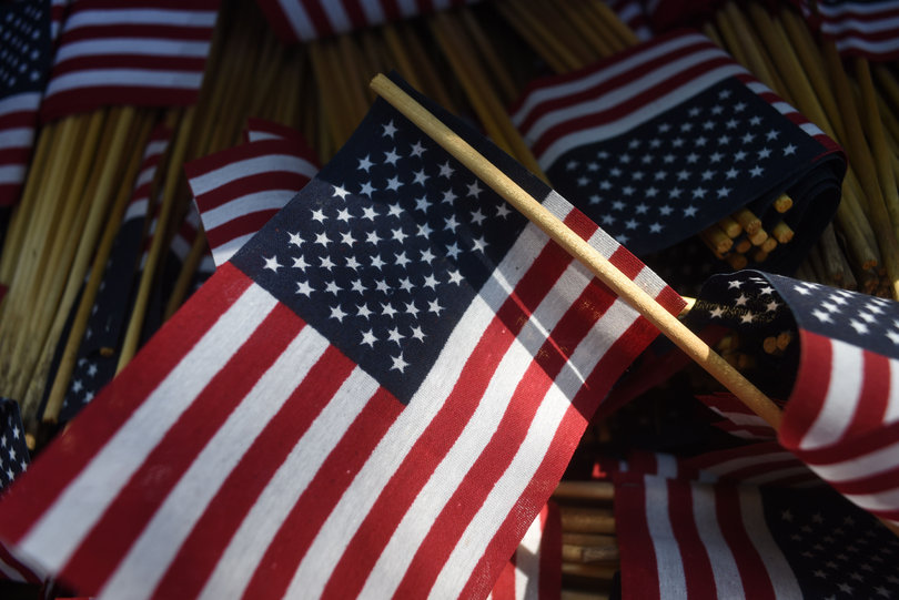 Several U.S. flags are prepped for placement on one of the main infields at SU. Five students who attend the university placed the flags in remembrance of 9/11. 