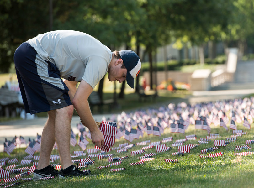 Wyatt Suling, a junior in the College of Arts and Sciences, fills a field with American flags in remembrance of 9/11. Suling, a member of the College Republican National Committee, helped lead this effort to honor victims of the attacks.