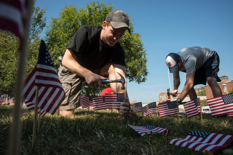 Adam Offutt, a sophomore at SU, and Wyatt Suling, a junior in the College of Arts and Sciences, fill a field with American flags in remembrance of 9/11. Nearly 3,000 people died during the attack 14 years ago and each year, colleges around the country honor the victims with acts such as this. 