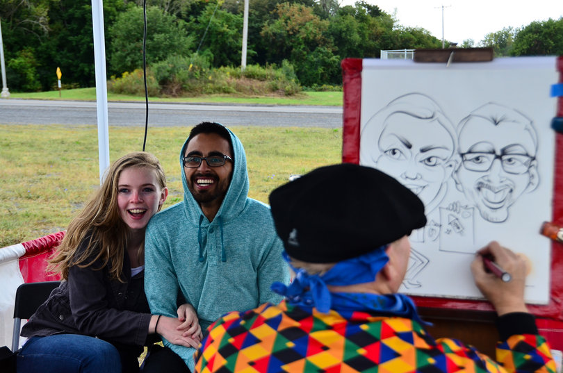 Sara Gatcomb, a senior broadcast and digital journalism major, and Ranbir Dhillon, a junior aerospace engineering major, were the first people to get their caricature drawn at one of the side stations at the event.