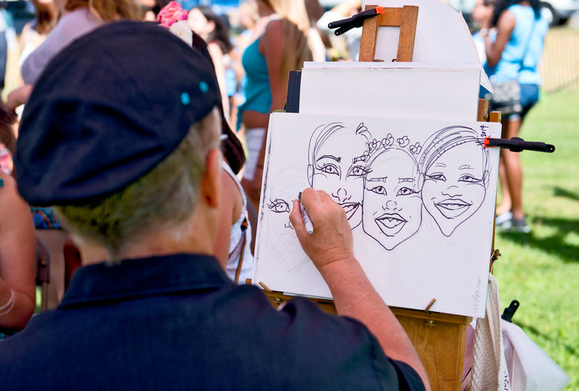 Artists drew caricatures of concertgoers. Besides the music stages, UU also brought in bouncy castles and a Direct TV station broadcasting the day's football games.