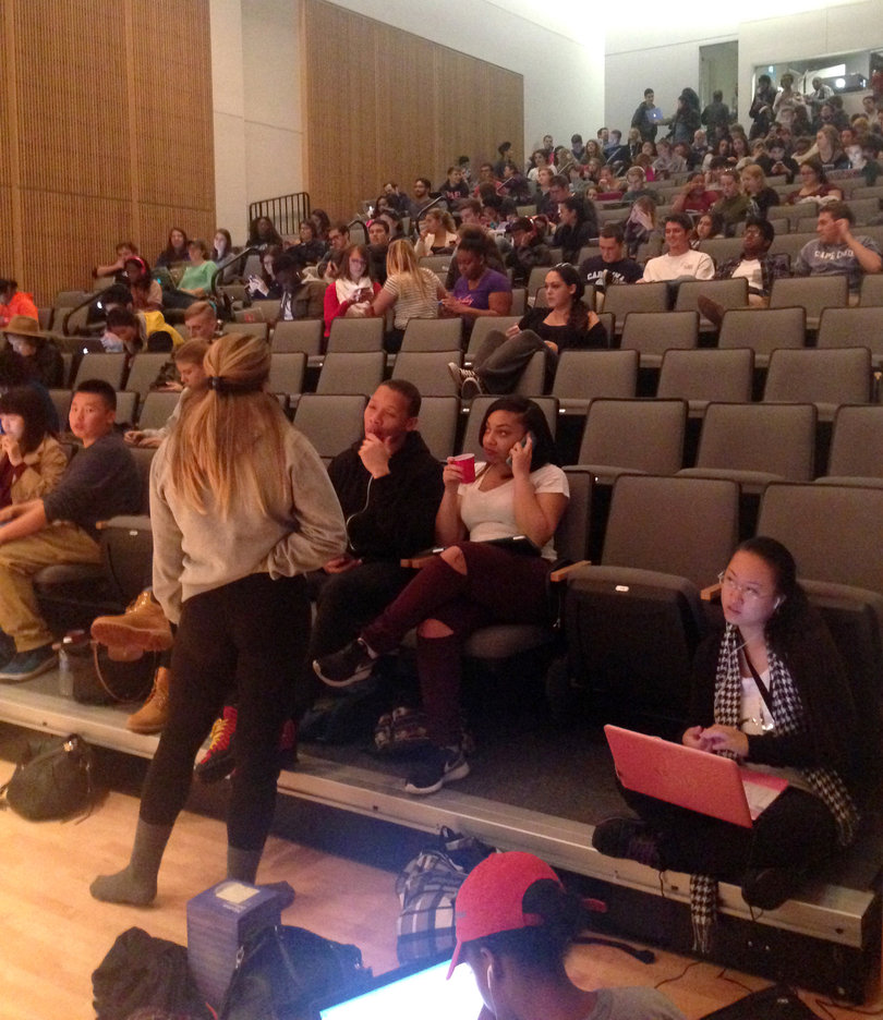 More students file into the Joyce Herganhan Auditorium inside Newhouse III as the Syracuse University campus remained in a lockdown situation.