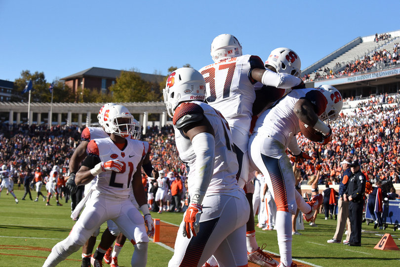 The Syracuse defense celebrates the Orange's first touchdown of the game, which gave SU a 7-0 lead. 
