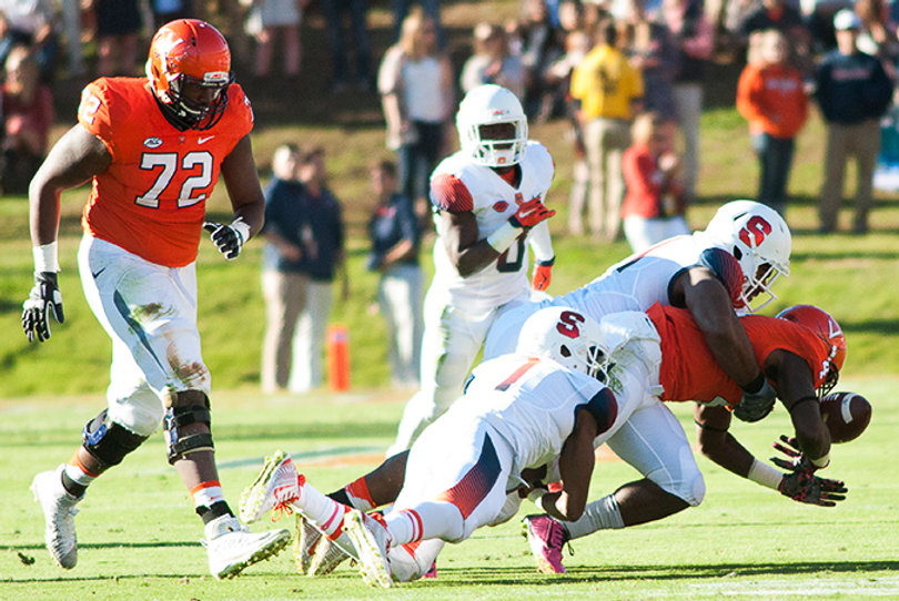Julian Whigham (1) and Donnie Simmons wrap up UVA running back Taquan Mizzell and force a fumble, leading to SU's first touchdown. 
