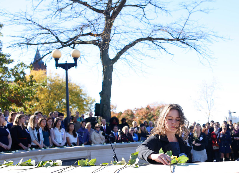 2014: Lockerbie Scholar Megan Noble, lays a rose in memory of Andrew McClume.