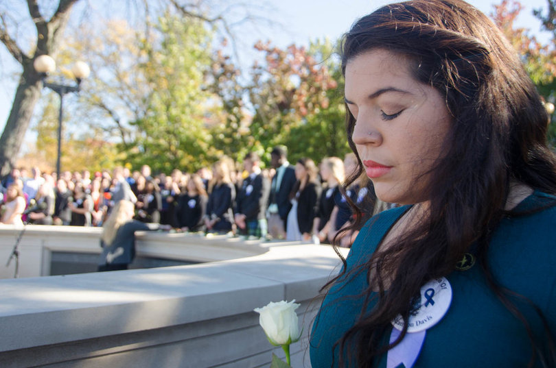 2014: Alexandra-Marie Miranda, a dual anthropology and international relations major and Remembrance Scholar, waits to lay her rose in commemoration of the Lockerbie victims.