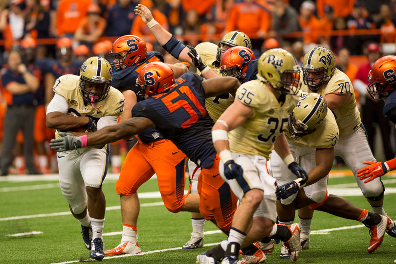 Orange defensive lineman Donnie Simmons (51) reaches his arm out to stop Ollison. 