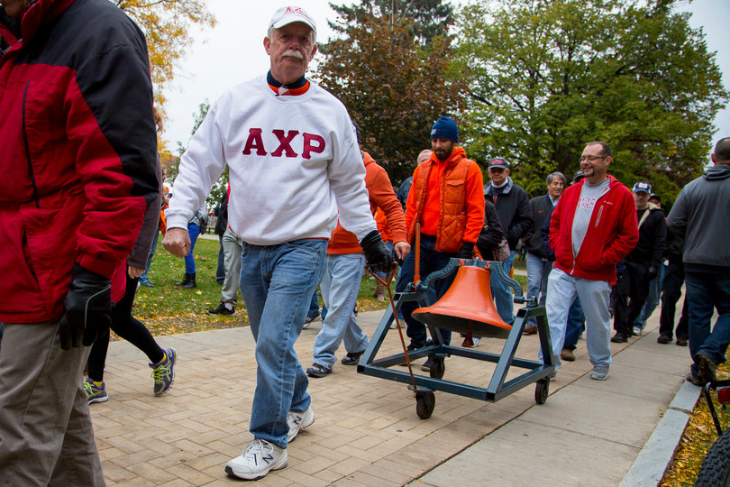 Barry Gottshall, from the Class of 1969, pulls the bell towards the Carrier Dome.  