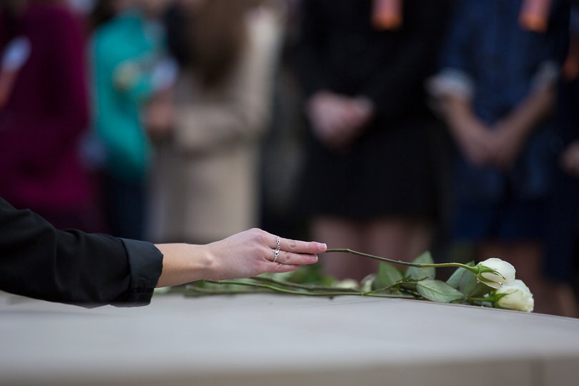 Scholars placed white roses on the Remembrance Wall to honor the lives that were lost.