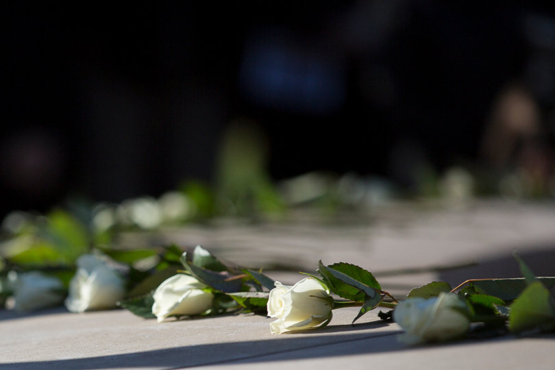 Scholars placed white roses on the Remembrance Wall to honor the lives that were lost.