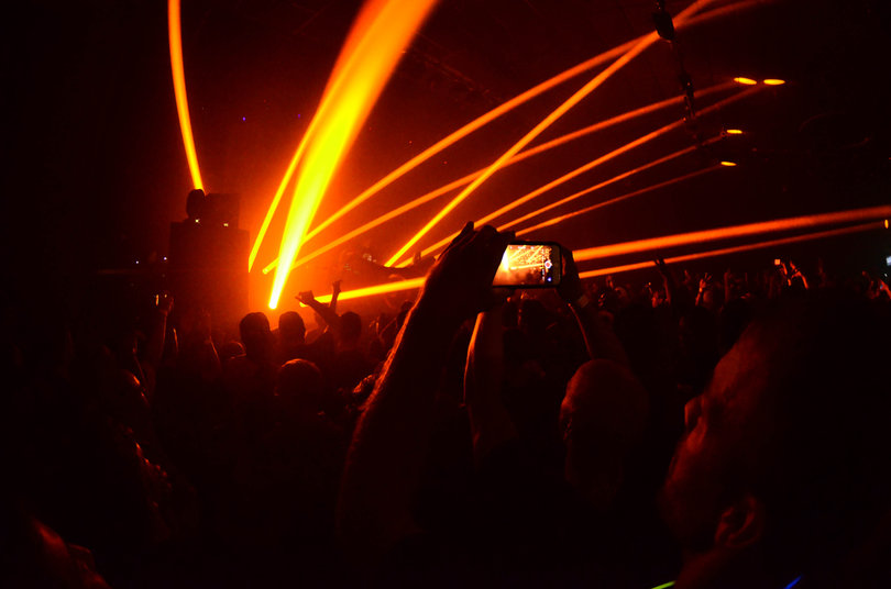 A man captures a photo of the performance. 