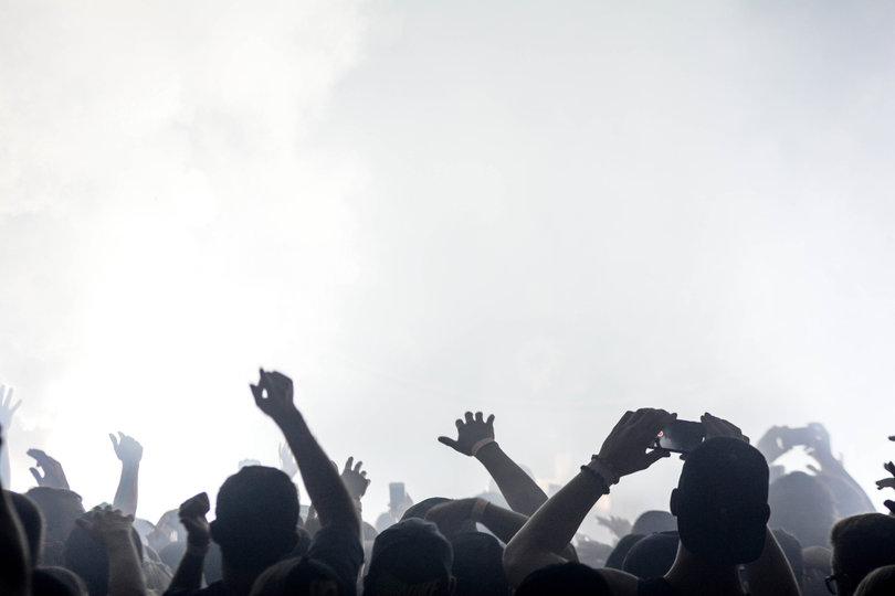 Ravers throw their hands in the air during Flux's set.