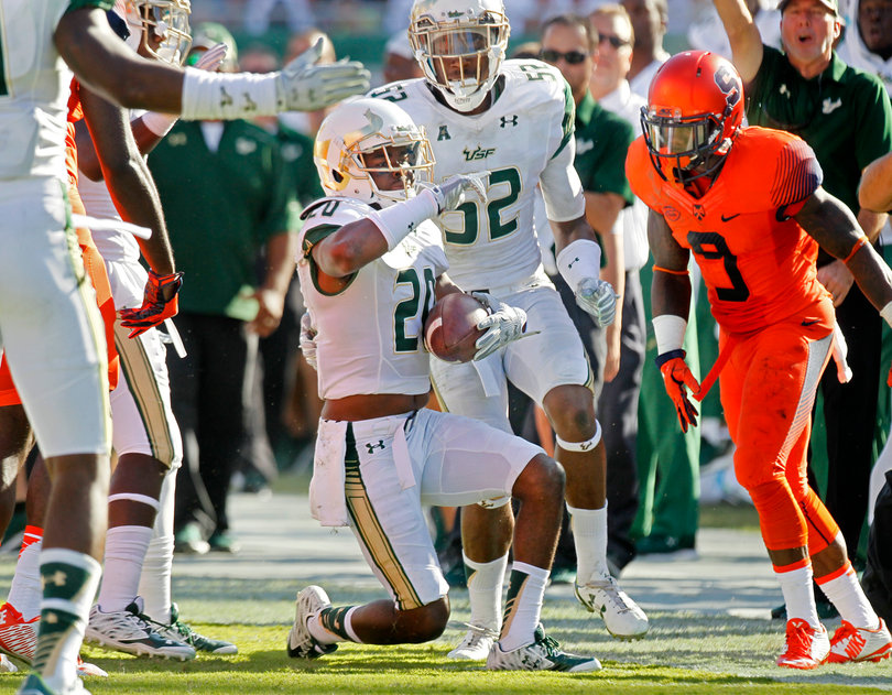 Abraham celebrates recovering the punt as SU's Brisly Estime, who was back to return, looks on.