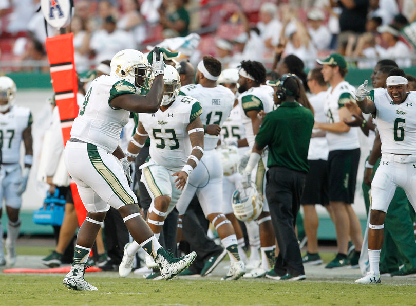 USF defensive end Demetrius Hill (9) celebrates making a defensive stop against the Syracuse offense on Saturday.