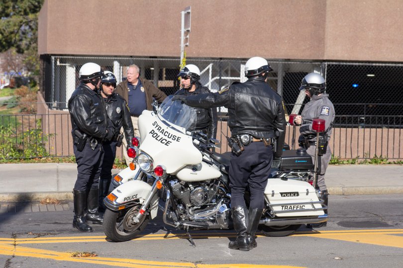 Syracuse Police Department officers gathered near the Sheraton Hotel on Waverly Avenue in preparation for the vice president's visit.