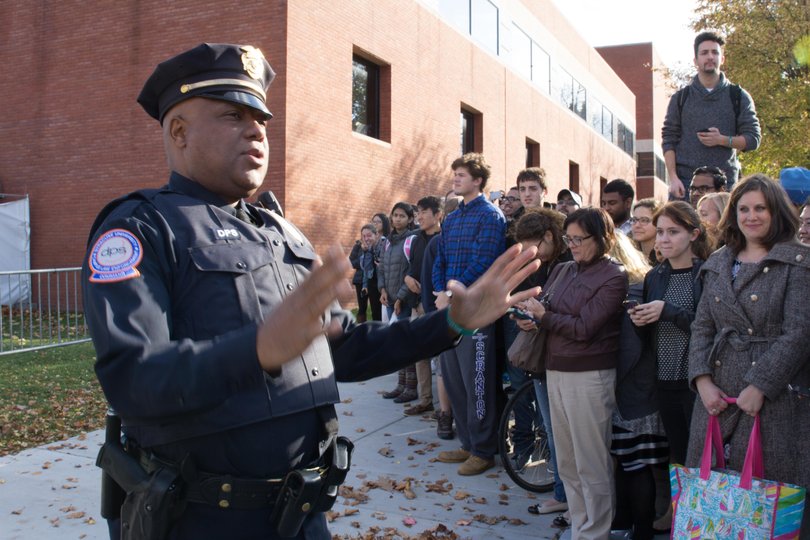 A Department of Public Safety officer addresses the crowd outside of the Schine Student Center in preparation for Biden's departure.