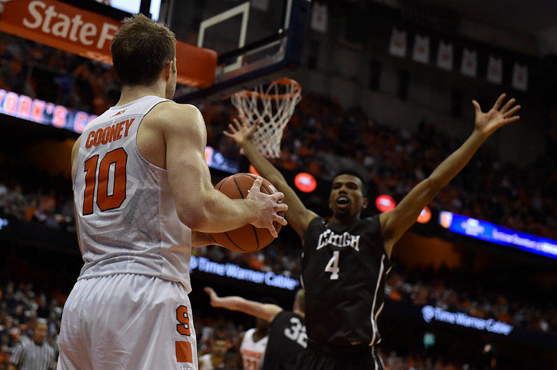 Cooney looks beyond the Lehigh defender as he inbounds the ball for Syracuse in its season-opening win.