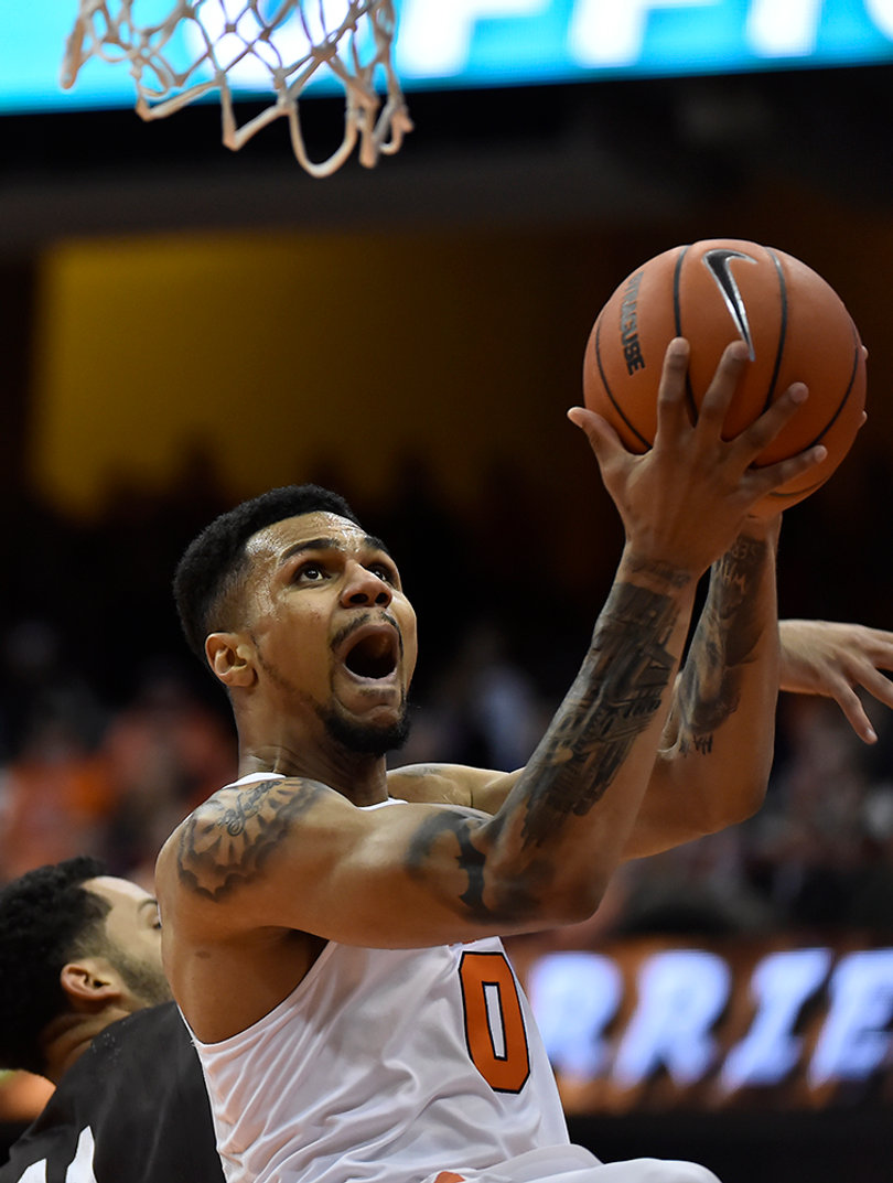 Gbinije's mouth opens as he looks toward the basket, rising with the ball in his hand.