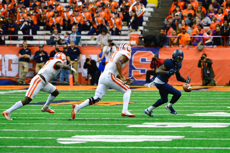 Two Clemson defenders look to close in on a Syracuse player.