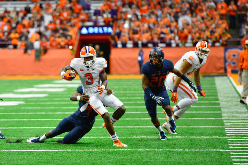 Scott looks to break a tackle from a Syracuse defender.