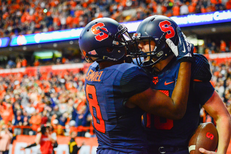 Wide receiver Steve Ishmael (8) and quarterback Zack Mahoney embrace each other.