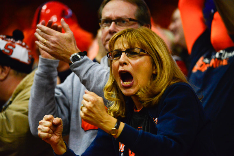 A fan yells toward the field.