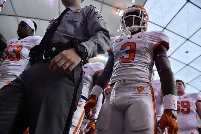 Artavis Scott (3) stands next to a sheriff. He had 12 receptions for 73 yards.