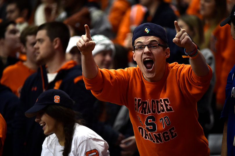 A Syracuse fans cheers and holds up his two index fingers. The Orange lost to the No. 1 team in the country.