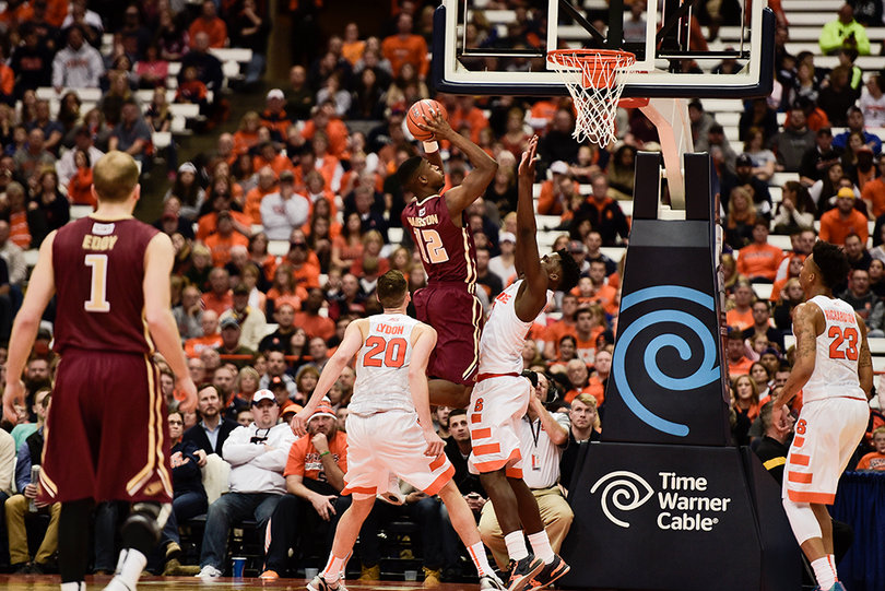 Elon forward Christian Hairston leaps up over an SU defender for a layup attempt. Hairston finished with just three points. 