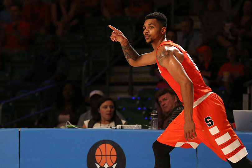 Point guard Michael Gbinije points up the court. He's scored 16 points and made 6-of-8 shots so far. 
