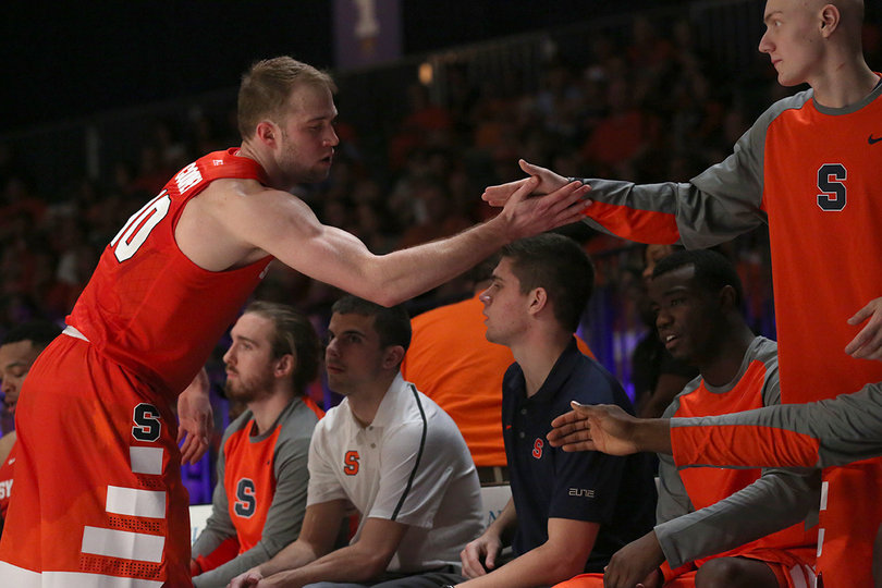 Cooney shakes hands with walk-on Evan Dourdas after subbing out.