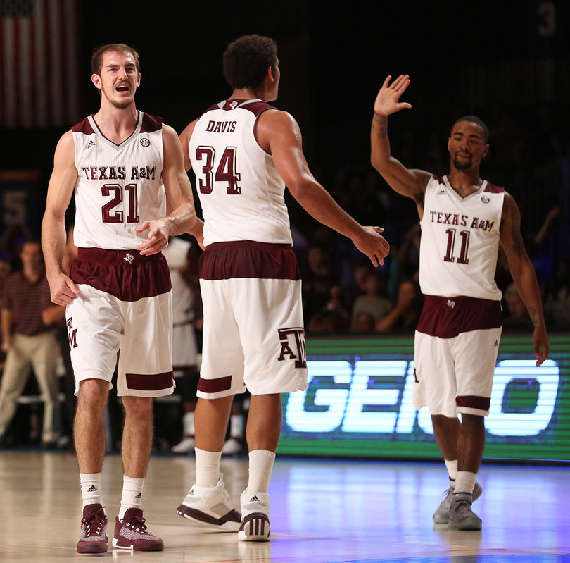 Anthony Collins (11) lifts his hand up in celebration. Texas A&M beat Texas 84-73.