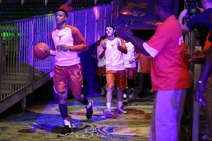 Texas jogs out of the locker room and onto the makeshift court in what is usually known as the Imperial Ballroom.