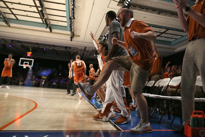 The Texas bench explodes after a big play.