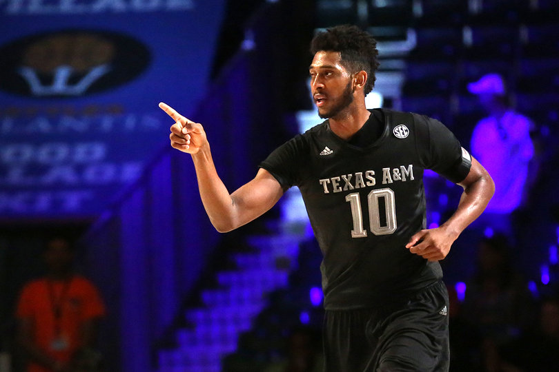 Texas A&M center Tonny Trocha-Morelos points to a teammate. He scored 14 points for the Aggies, good for second on the team. 