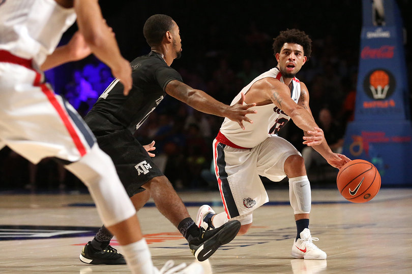 Gonzaga guard Josh Perkins tries to thread a past around his defender. Perkins scored 15 points against the Aggies on Thursday. 