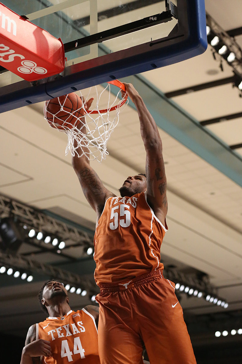 Texas center Cameron Ridley (55) throws down a dunk as teammate Prince Ibeh (44) stands under the basket. Ridley registered a double-double with 13 points and 11 rebounds. 